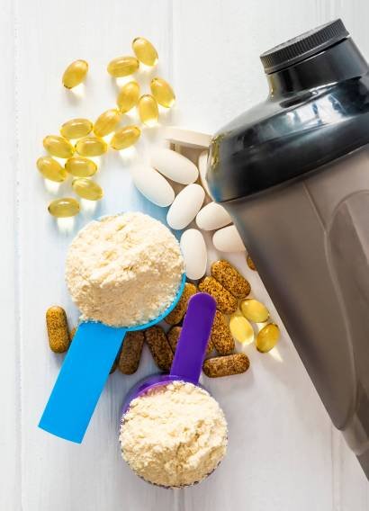 Sport Pills,vitamins and protein powder with brown bottle composed on the white table